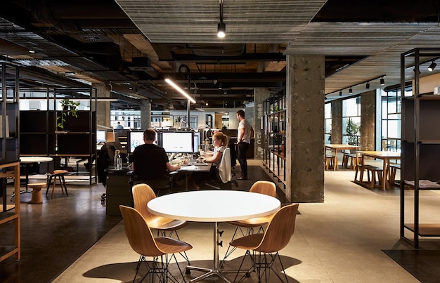 a group of people are sitting at a table in a restaurant