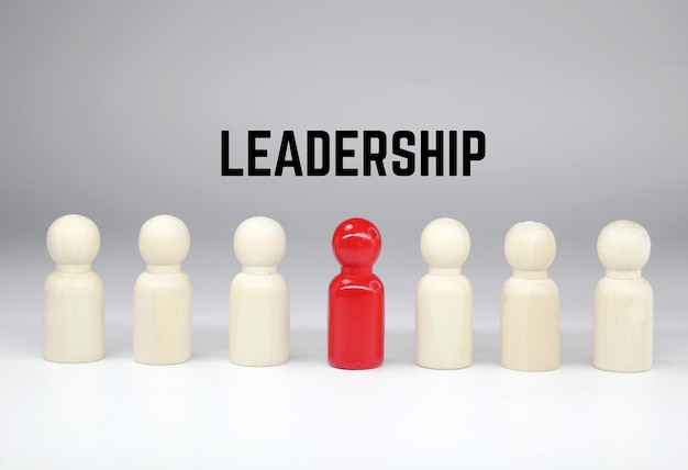 Photo a group of people are standing in a row with the word leadership above them.