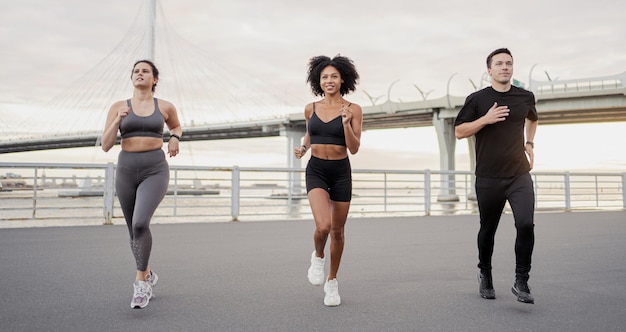 A group of people are training running fitness in the city Use a fitness watch bracelet on the arm