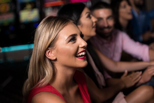 Group of People at Automat Machine in Casino