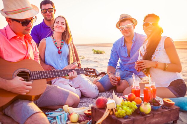 Group of people at beach against sky