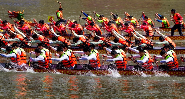 Group of people boat racing in water