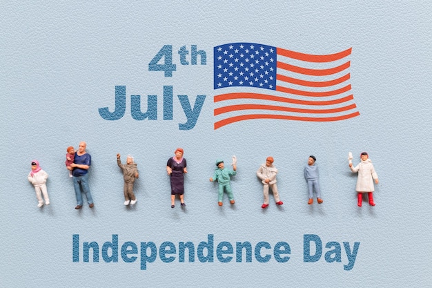 Group of people celebrating the Fourth of July with the American flag in the background