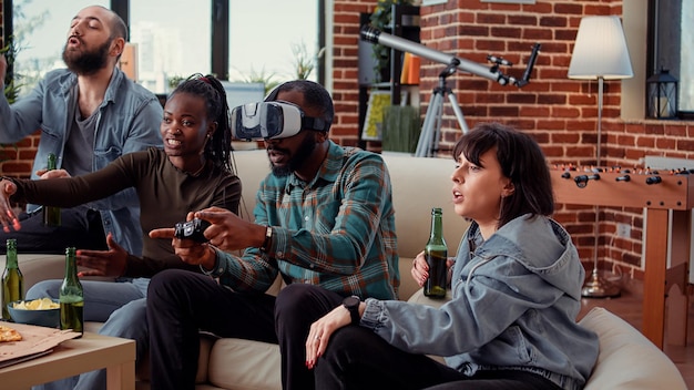 Group of people celebrating video games win with vr glasses and
tv console, playing online challenge. winning gameplay competition
with virtual reality 3d headset, having fun at hangout.