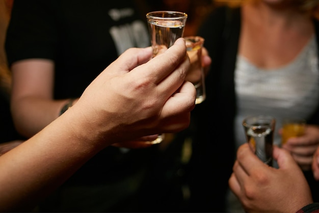 a group of people clink glasses