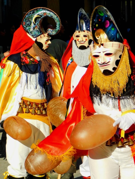 A group of people in costumes with one wearing a mask