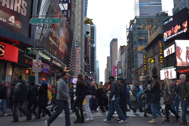 group of people crossing city street