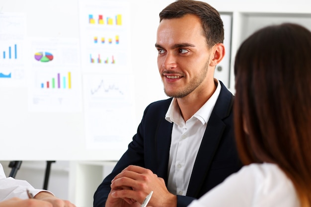 Group of people deliberate on white board problem