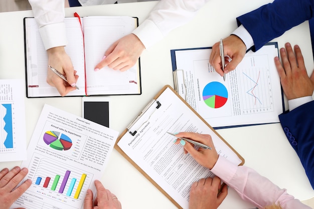 Group of people discuss plan at workplace closeup