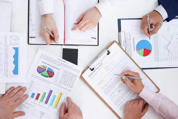 Group of people discuss plan at workplace closeup