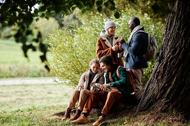 Group of people eating food outdoors