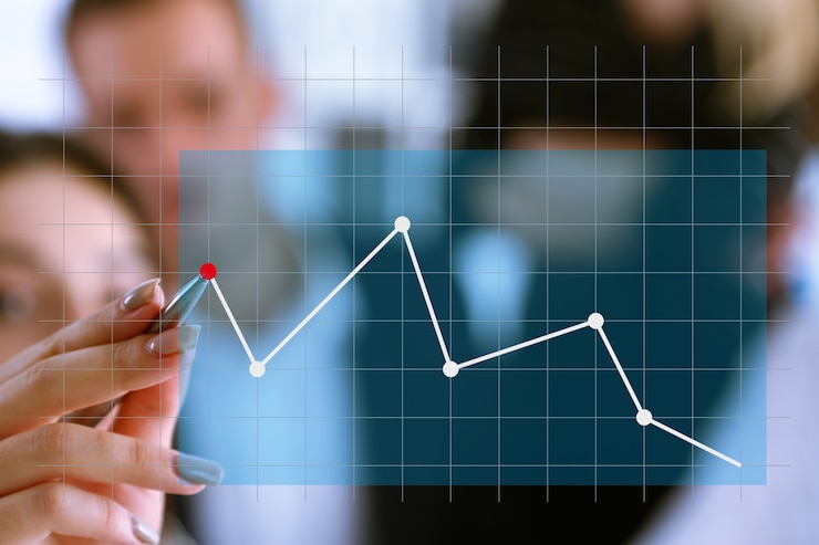 Photo a group of people examines the financial statistics of an enterprise pointing with a hand with a pen on the graph point