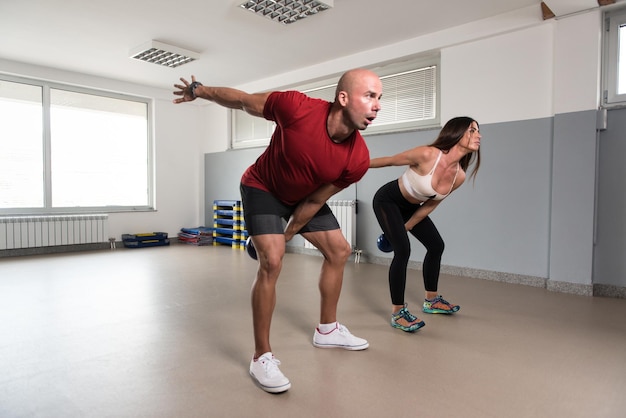 Group Of People Exercise With Kettle Bell