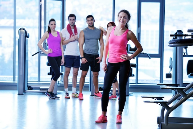 Group of people exercising at the gym and stretching