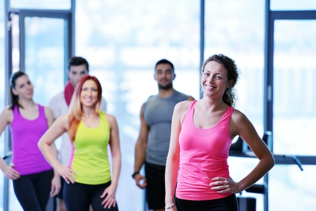 Group of people exercising at the gym and stretching