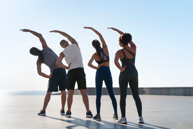 Group of people exercising together outdoors