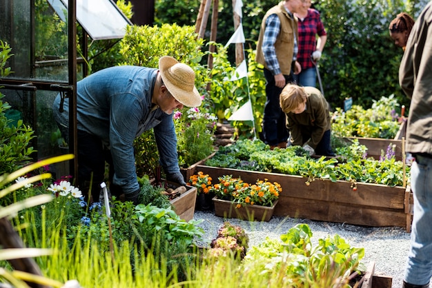 Group of people gardening backyard together