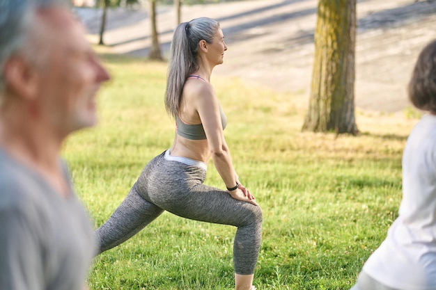 Group of people having a workout and doing lunges together