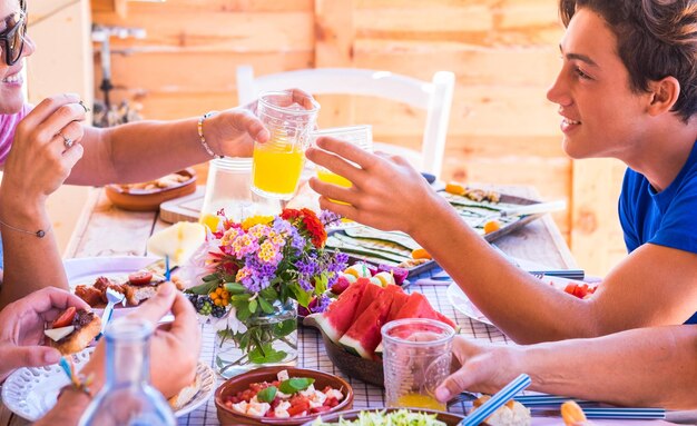 Group of people holding drink at table