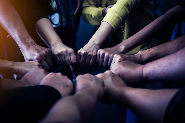 Group of people joining their hands