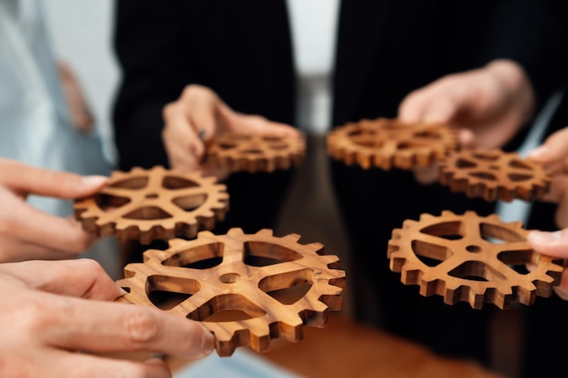 Photo group of people making chain of gears into collective form for harmony symbol