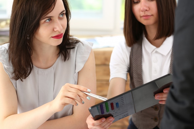 Group of people in office look at mobile tablet pc