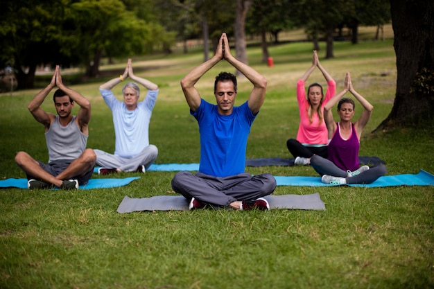 Group of people performing yoga