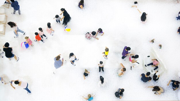 Group of people play and run on the white bubble\
playground