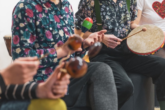 Group of people playing on different kinds of musical instruments during music therapy