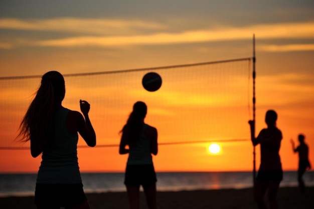 Photo a group of people playing volleyball on a beach at sunset