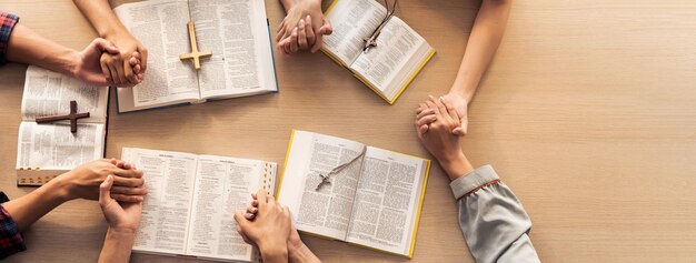 Group of people praying together while holding hand Top view Burgeoning