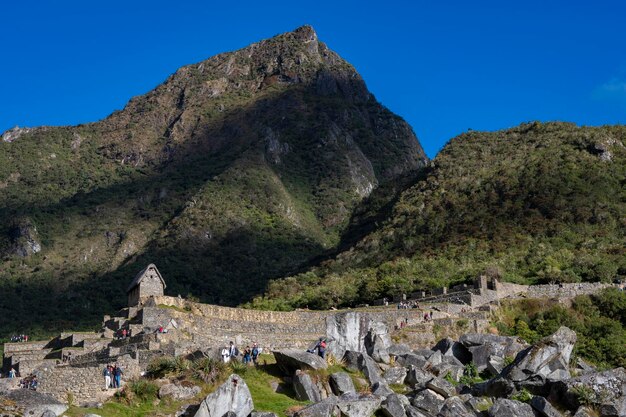 Group of people on rocks against mountain range