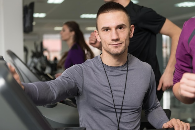 Group Of People Running On Treadmills In Gym