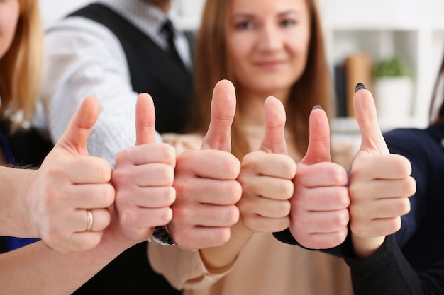 Group of people show OK or confirm with thumb up during conference