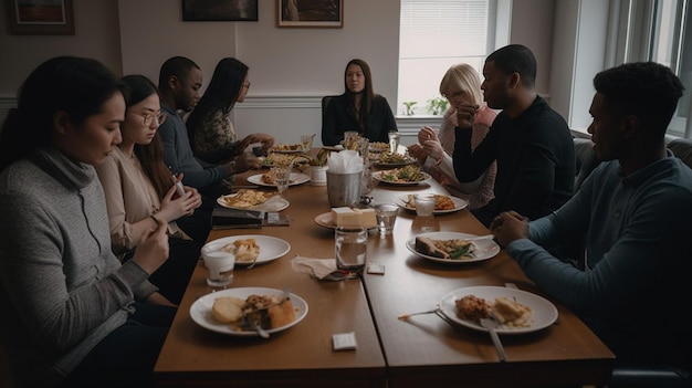 A group of people sit around a table with food on it and one of them is eating.