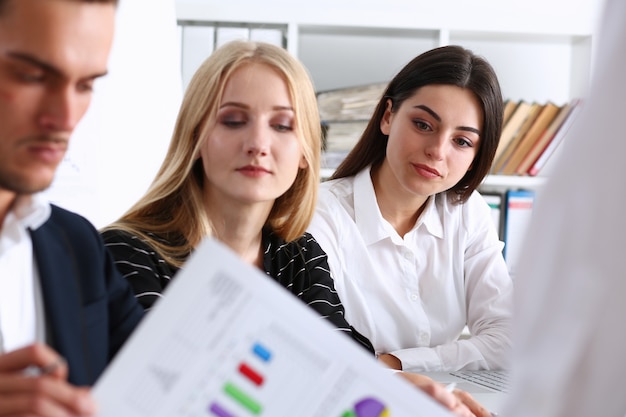 Group of people sit in office deliberate on problem