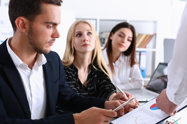 Group of people sit in office deliberate on problem