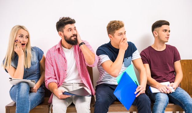 Group of people sitting on chairs waiting interviews