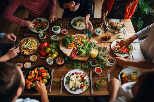 A group of people sitting at a table enjoying a meal together This image can be used to depict family gatherings dinner parties or restaurant scenes