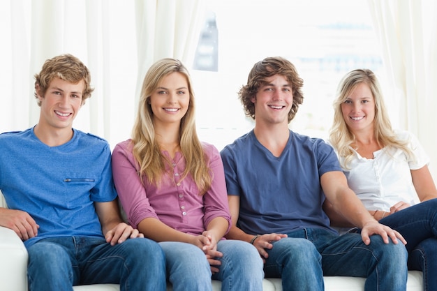 A group of people sitting together on the couch