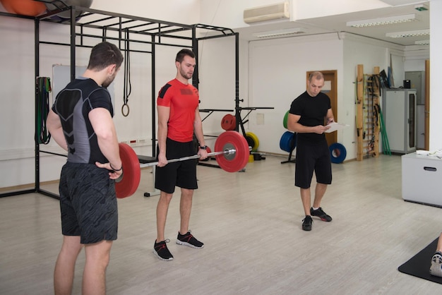 Group of People in Sport Fitness Gym Weight Training Equipment Indoor