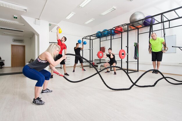 Group of People in Sport Fitness Gym Weight Training Equipment Indoor