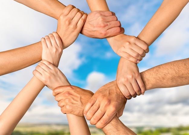 Group of people stacking hands together