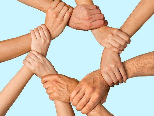 Group of people stacking hands together