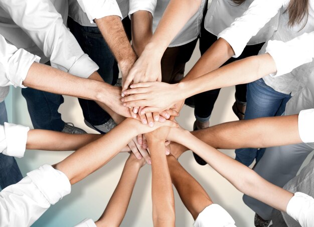 Group of people stacking hands together