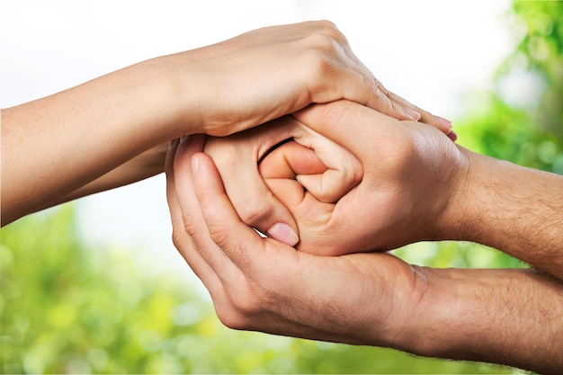 Group of people stacking hands together