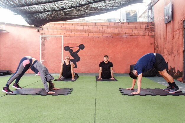 A group of people stretching before training.