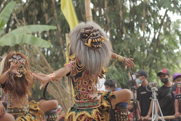 A group of people in traditional dress dancing in front of a crowd.