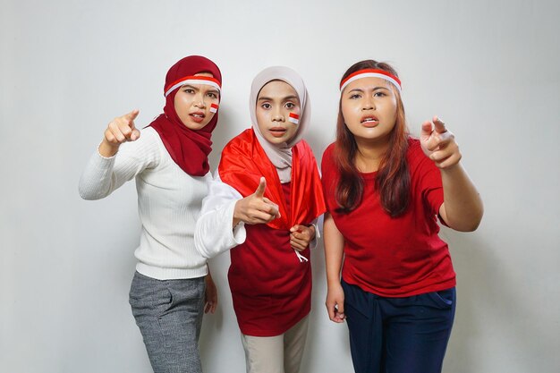 group of people using the red and white attributes to commemorate Indonesia independence day