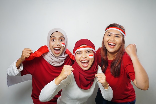 group of people using the red and white attributes to commemorate Indonesia independence day